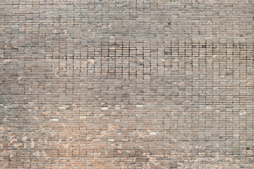 Weathered stained old brick wall background on surface