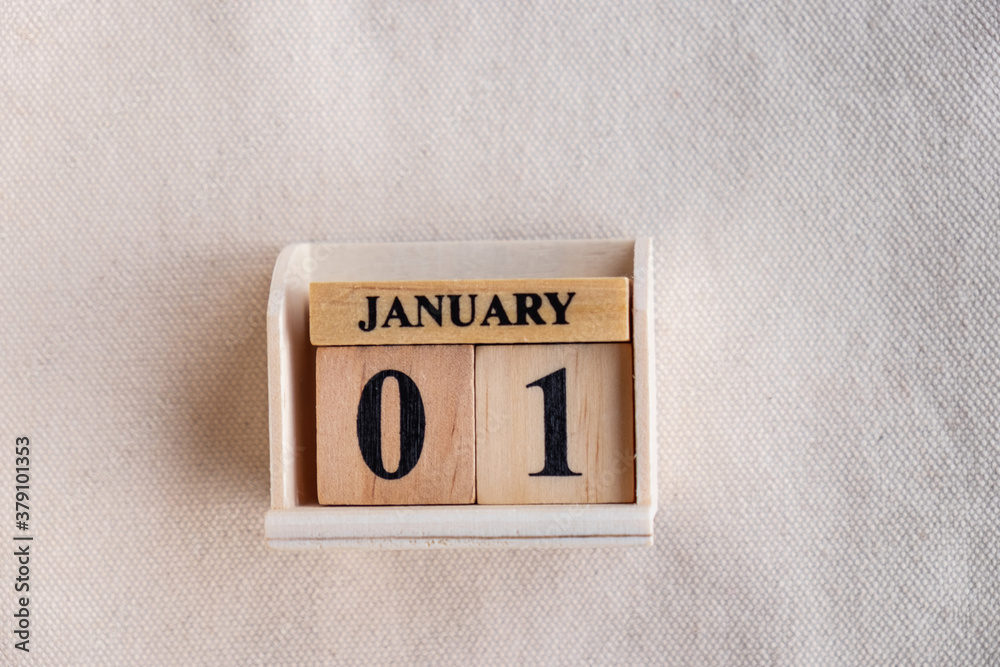Fototapete january 1st. image of jan 1 wooden color calendar on white canvas background. empty space for text. 