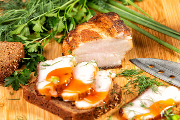 smoked meat lies on the table with herbs and sauce