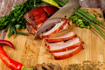smoked meat lies on the table with herbs and sauce