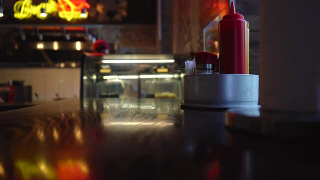 cooks prepare food in a dim diner