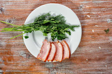 smoked meat lies on the table with herbs and sauce