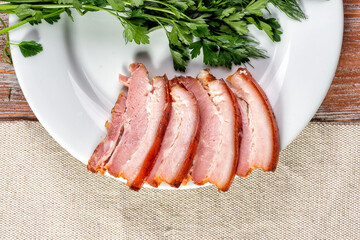 smoked meat lies on the table with herbs and sauce