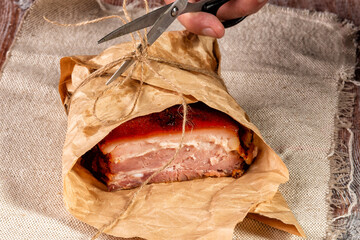 smoked meat wrapped in wrapping paper and tied with twine