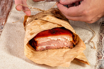 smoked meat wrapped in wrapping paper and tied with twine