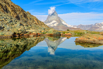 Reflection of Mount Matterhorn on Riffelsee Lake in Zermatt, mountain resort in Swiss Alps, Canton...
