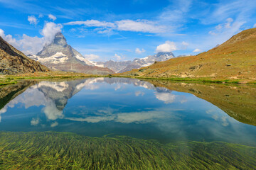 Reflection of Mount Matterhorn on Riffelsee Lake in Zermatt, mountain resort in Swiss Alps, Canton of Valais, Switzerland. Riffelsee is located on Riffelseeweg trail on Gornergrat Bahn cog railway.