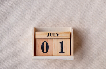 July 1st. Image of July 1 wooden color calendar on white canvas background. empty space for text