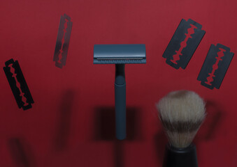 Double-edge safety razor and blades on a red background floating in the air