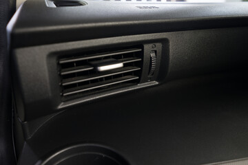 Fototapeta na wymiar Air conditioner vent grill in a modern car