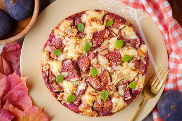 A pie with figs, walnuts and cheese. Autumn still life horizontal composition