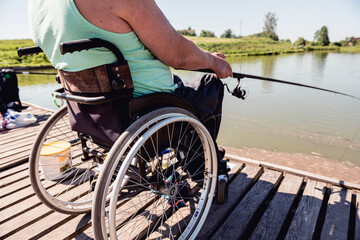 Young disabled man in a wheelchair fishing.