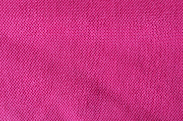 Fabric knitting wool texture pink color. Cloth knitted wool surface.