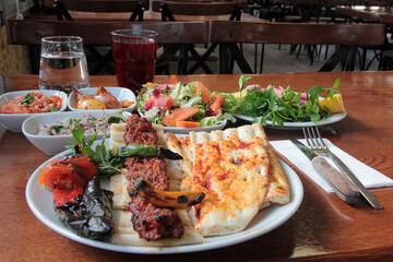 delicious Adana kebabs and salads on the plate