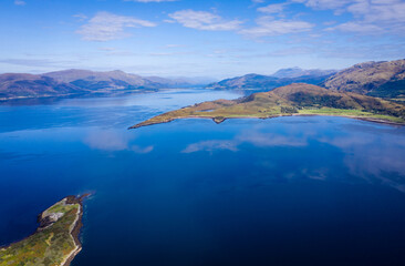 aerial view of balnagowan island and loch linnhe near fort william and ben nevis during a calm clear blue day in autumn in the argyll region of the highlands of scotland