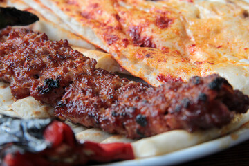 delicious Adana kebabs and salads on the plate