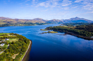 Fototapeta premium aerial view of the falls of lora near connel, connel bridge and oban in the argyll region of the highlands of scotland during a clear blue autumn day
