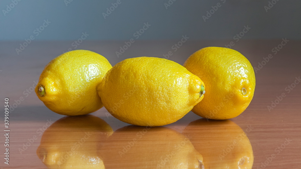 Wall mural Lemon on a wooden table