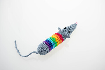 Knitting rat doll. Concept: year of the rat according to the Eastern calendar. The doll is knitted by hand on a white background. Rat toy. Miniature crochet. with copy space for your text