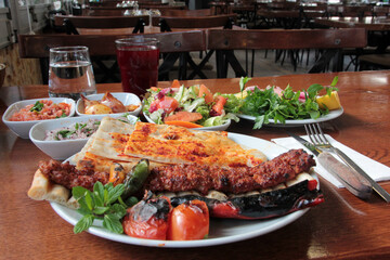 delicious Adana kebabs and salads on the plate