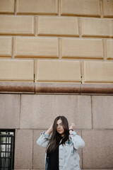 Portrait of a beautiful young woman with natural light outdoors in the city