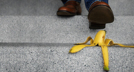 Accident in Daily Life Concept. Man Stepping Down Stair on a Banana Peel. Insurance or Business...