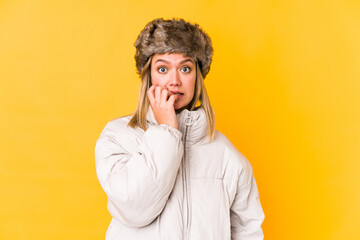 Fototapeta na wymiar Young caucasian woman wearing a winter clothes isolated biting fingernails, nervous and very anxious.