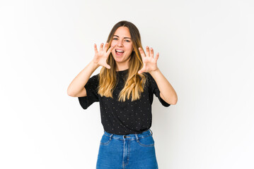 Young caucasian woman isolated on white background showing claws imitating a cat, aggressive gesture.