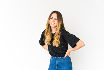 Young caucasian woman isolated on white background suffering a back pain.