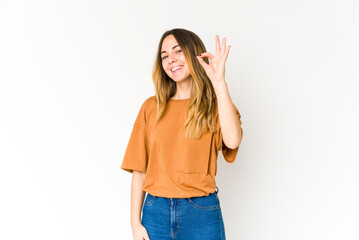 Young caucasian woman isolated on white background cheerful and confident showing ok gesture.