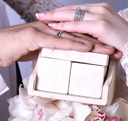 Woman and man holding wedding rings, close-up,
