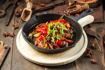Roasted beef with vegetables in cast iron pan