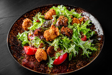 Caesar salad with croutons, cheese, eggs, tomatoes and grilled chicken on wooden table.