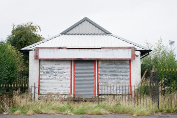 Derelict abandoned shop business in poor housing crisis ghetto estate slum Paisley