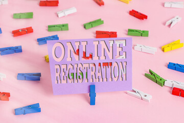 Handwriting text writing Online Registration. Conceptual photo System for subscribing or registering via the Internet Colored clothespin papers empty reminder pink floor background office pin