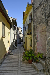 Fototapeta na wymiar A narrow street among the old houses of Baselice, a small town in the province of Benevento, Italy.