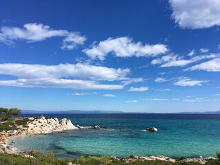 Sunny rock coast in Greece with clody sky 