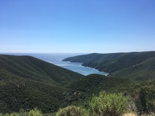 Mountain landscape on sunny summer day with clear sky in Greece with sea gulf on background