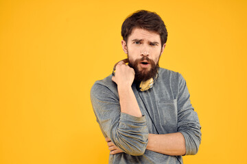 Man with headphones music lifestyle lifestyle technology yellow background