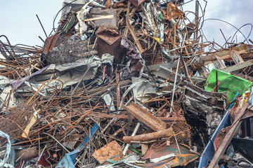 Pile of scrap metal on the garbage dump territory.