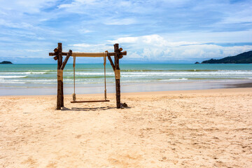 Exotic tropical paradise swings over crystal clear turquoise blue ocean sea water landscape seascape at Patong Beach, Phuket, Thailand