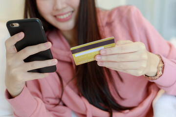 Young Asian woman holding credit card