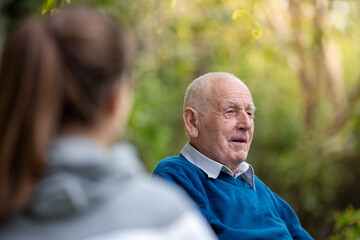 Old man talking to granddaughter
