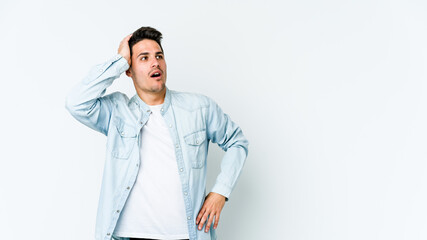 Young caucasian man isolated on white background being shocked, she has remembered important...
