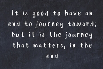 Chalk inscription of smart quote on black desk