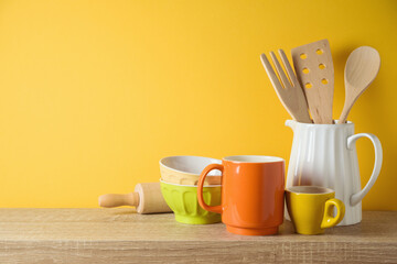 Kitchen utensils and dishware on wooden shelf. Autumn kitchen interior background