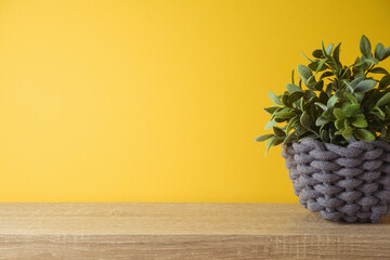 Empty wooden shelf with plant over yellow wall ibackground. Kitchen mock up for design