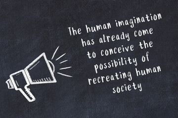 Chalk loudspeaker and wise quote on black desk