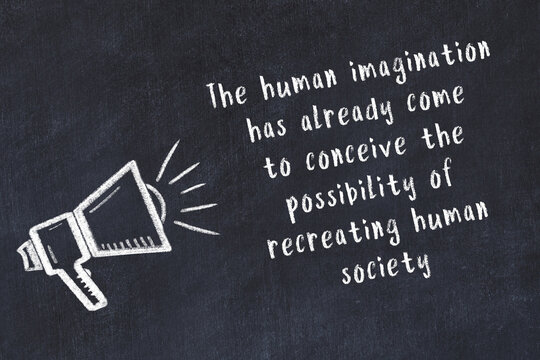 Chalk loudspeaker and wise quote on black desk