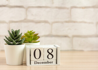 December 8 on the wooden calendar .Winter day, empty space for text.Calendar for December on a light background.